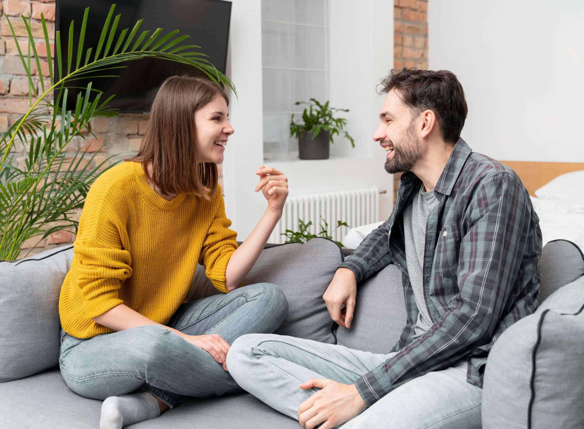 Couple talking on sofa